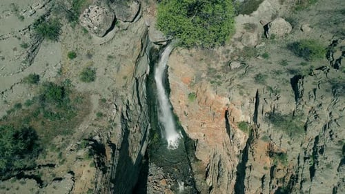 Aerial View of Breathtaking Waterfall in Wilderness