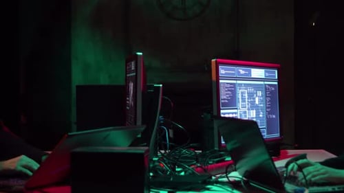 Coders Working on Computers in Dark Office at Night