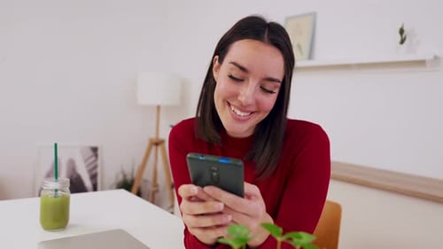 Smiling Woman Relaxing at Home Using Cell Phone Device