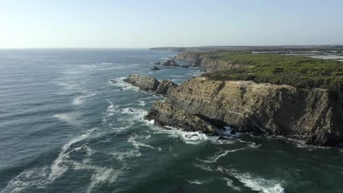 Aerial Drone View Of Rugged Coastal Cliffs And Blue Ocean