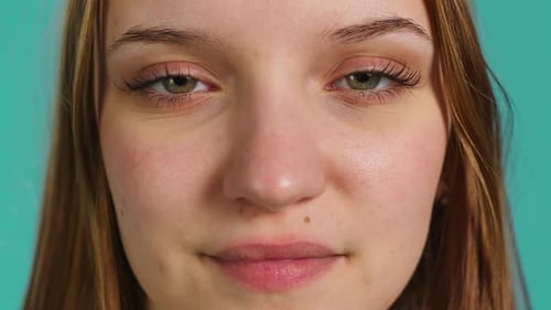 Close-Up of Young Woman Blinking and Smiling Face