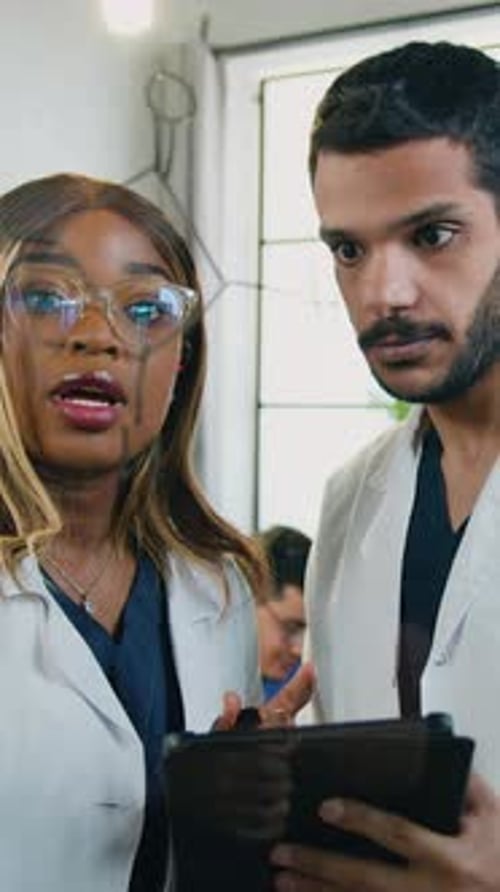 Doctors Collaborating, Drawing Medical Diagram on Glass in Hospital