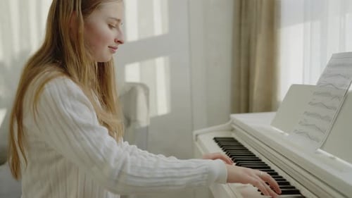 Teen Girl Plays Piano in a Sunlit Home