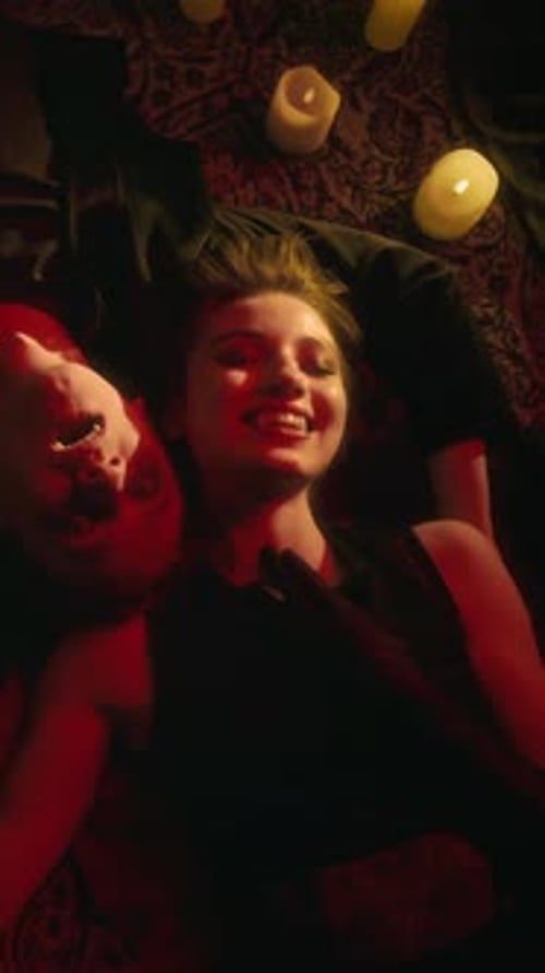 Vampire Couple Lying Close Together on Floor and Smiling