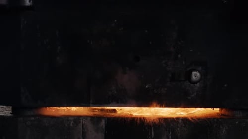 Super slow motion of industrial metal forging. Fire and sparks. Production of jet engine parts