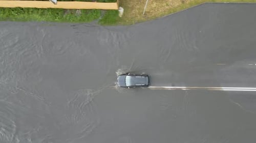 Aerial View of City Traffic with Cars Driving on Flooded Street After Heavy Rain