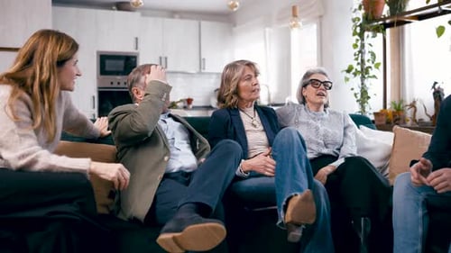 Group of Senior Friends Talking Together on a Sofa