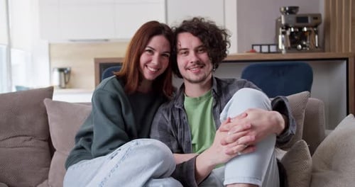 Happy Couple Relaxing Together on Living Room Couch