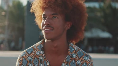 Front view of young happy man in the city, African American boy smiling