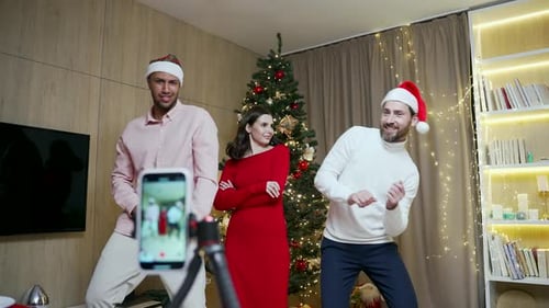 funny friends record reels stories front smartphone camera for social networks during New Year