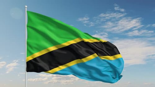 Realistic Tanzania Flag Waving in Wind Against Blue Sky