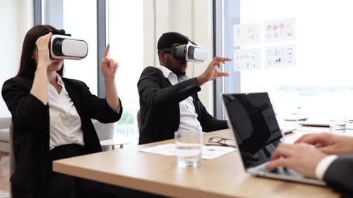 Business Professionals Using Virtual Reality in Modern Office