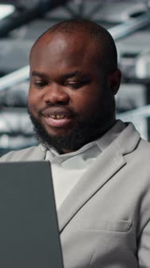 Vertical Video Computer Scientist Using Laptop in Data Center Managing Server Virtualization