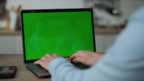Unknown Man Hands Typing on Mockup Computer Sitting at Kitchen Table Close