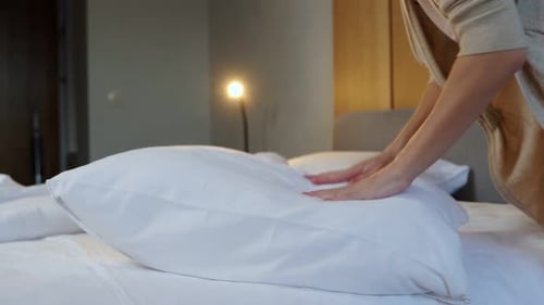 Woman Makes Bed at Home