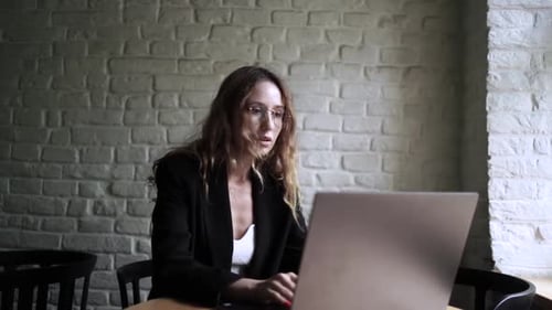 Young Woman Working on Her Laptop Computer in Coffee Shop