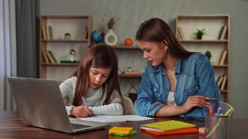 Young Child Girl Studying at Home Small Girl Sits at Desk and Attends School Class Online on Laptop