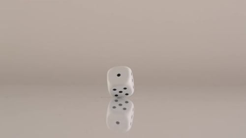 Dice Rolling in Slow Motion on White Background