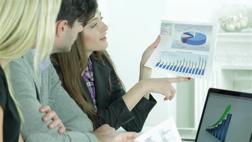 Business Meeting Analyzing Data Charts for Growth