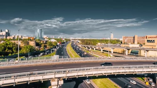 Cars On A Highway By The City Aerial