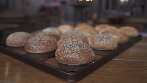 Rising close up view of homemade burgers bun in the trey.