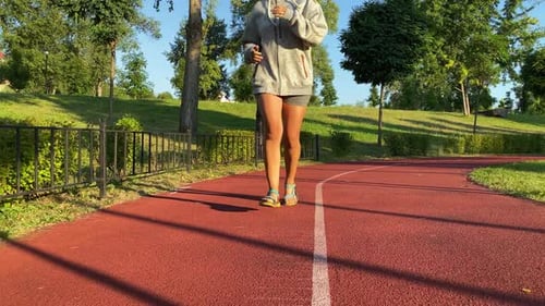Low Angle View Young Woman Jogging on Running Trail in Park Daybreak