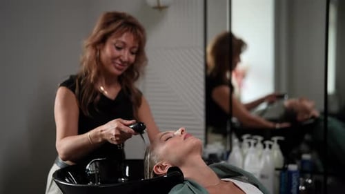 Blonde Woman Getting Hair Washed at Salon