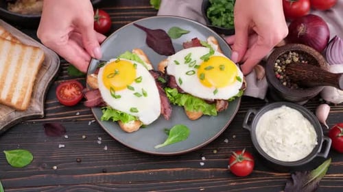 Egg Sandwich with Bacon on a Wooden Table