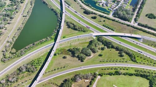 Aerial View of Freeway Overpass Junction with Fast Moving Traffic Cars and Trucks in American Rural