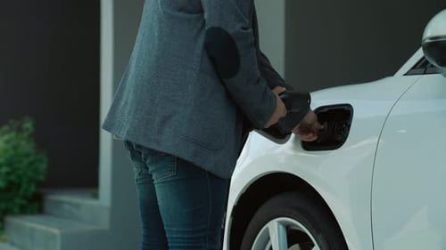 Progressive Man Unplugs the Electric Vehicle's Charger at His Residence