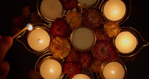 Lighting Candles in Decorative Bowl with Flowers