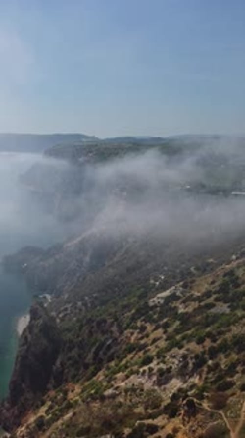 Aerial View Blue Sky Sun and Fog Over Calm Sea The Drone Flies Over Foggy and Fluffy Clouds Abstract