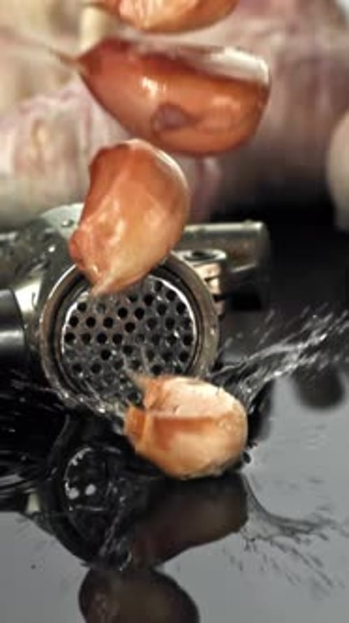 Garlic Falls on a Wet Surface with Splashes Filmed on a Highspeed Camera at 1000 Fps