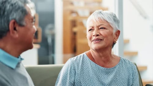 Senior Couple Talking and Laughing Together Indoors
