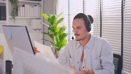 Asian professional businessman using laptop computer video call in office.