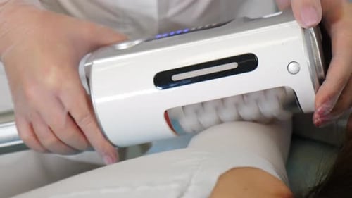 Medical Professional Using Device on Patient Leg