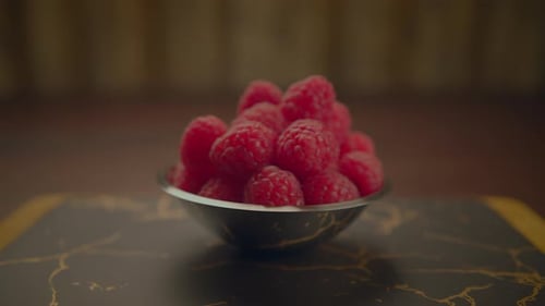 Fresh Ripe Raspberries and Blueberries Standing on Wooden Table
