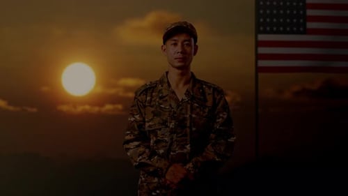 Sober Soldier Stands Proudly With Flag at Sunset