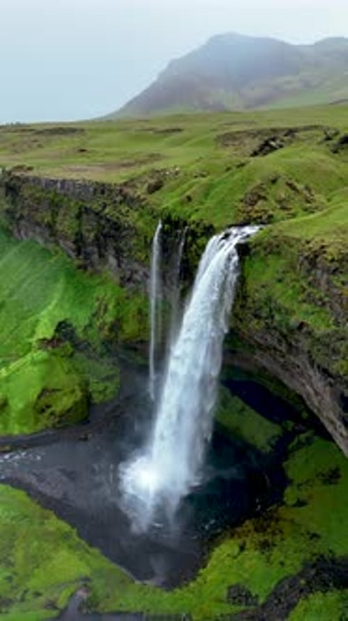 Aerial View of Iceland Waterfall Flowing into River
