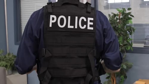 Police officer walking through an office