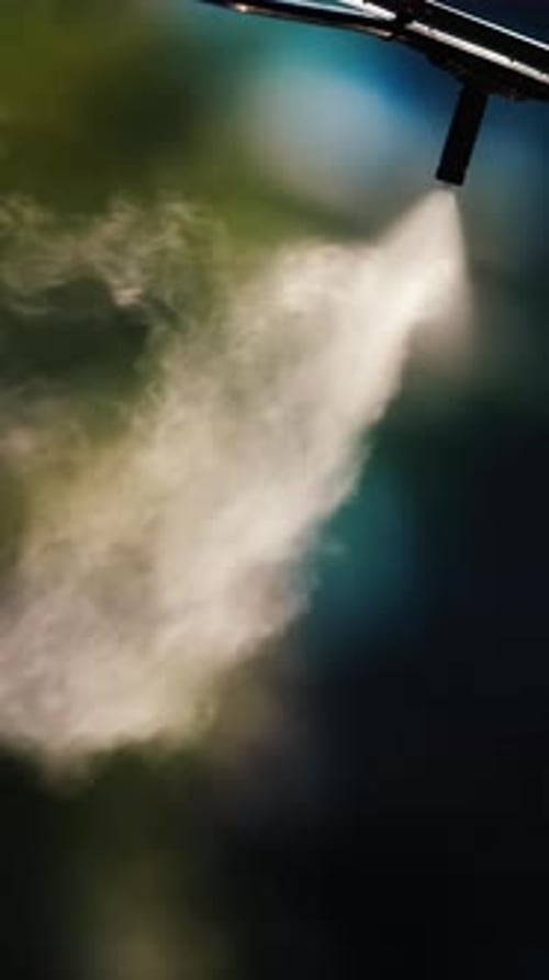 A jet of water spraying into the air against a dark background