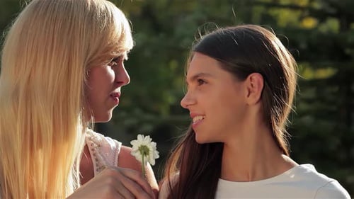 Two Women Share Tender Moment Outdoors