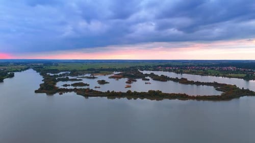 Aerial view shows a wide river winding through a rural landscape.
