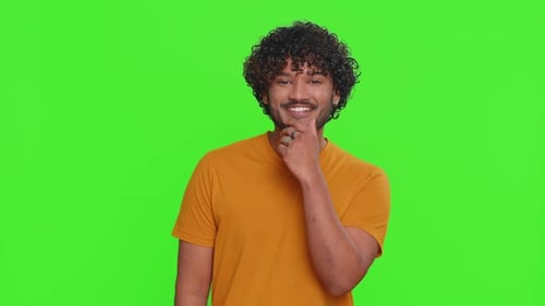 Smiling Man with Curly Hair Poses on Green Screen