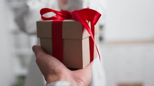 Man Giving Gift to Woman for Special Occasion