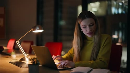 Woman Works Late at Computer in Office