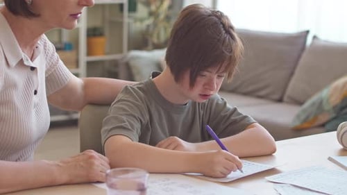 Woman Tutoring Child in a Sunlit Home