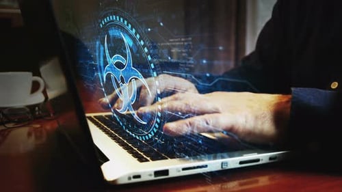 Biohazard danger alert symbol and man typing keyboard