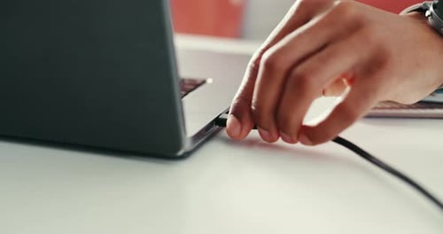Hands, person and cable to charge laptop for database transmission, information security