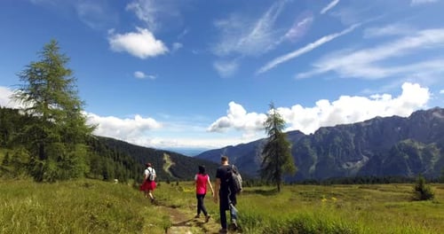 Portrait of people having a trekking tour and walking on a mountain path. Concept: Sport, travel,